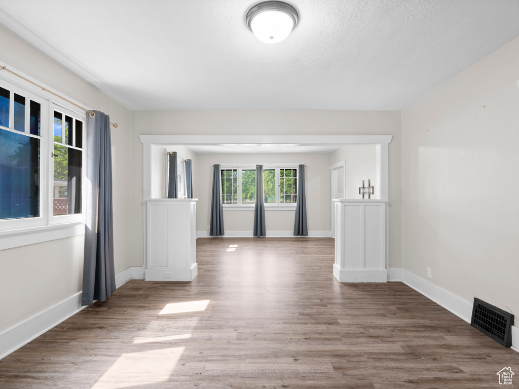 Spare room featuring wood finished floors and baseboards