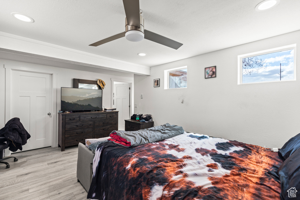 Bedroom with light wood-style flooring, multiple windows, recessed lighting, and a ceiling fan