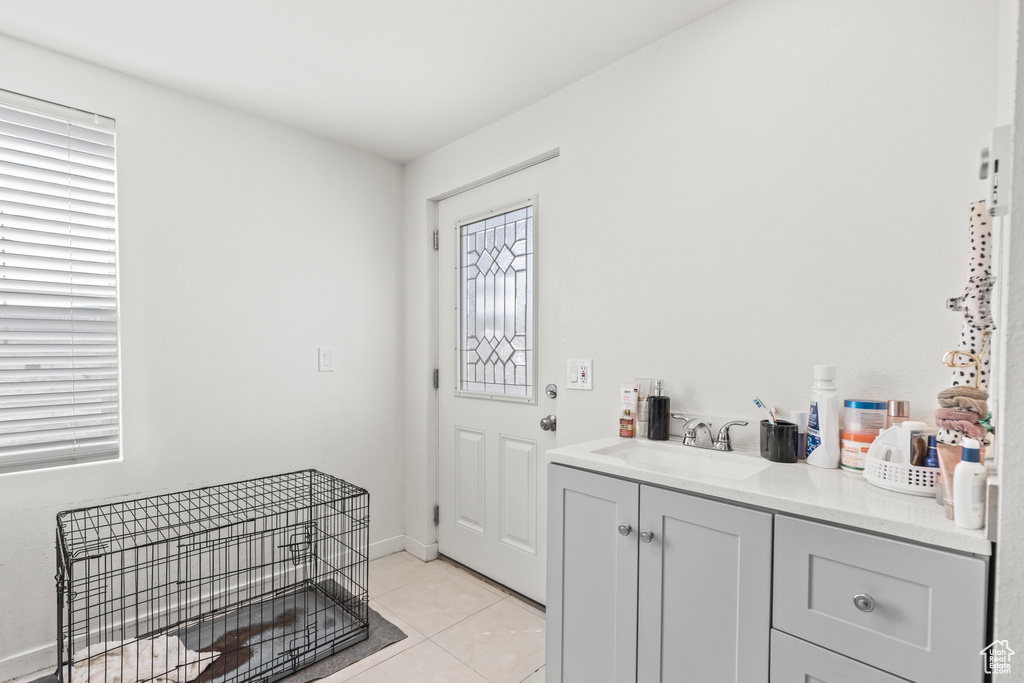 Foyer entrance featuring light tile patterned floors