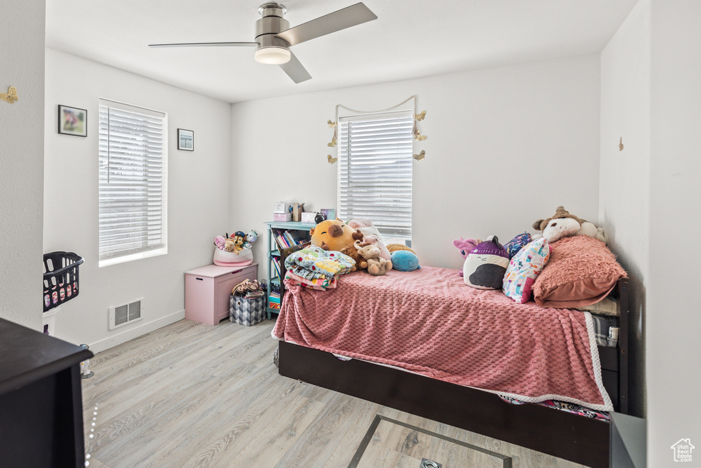 Bedroom featuring wood finished floors, a ceiling fan, and baseboards
