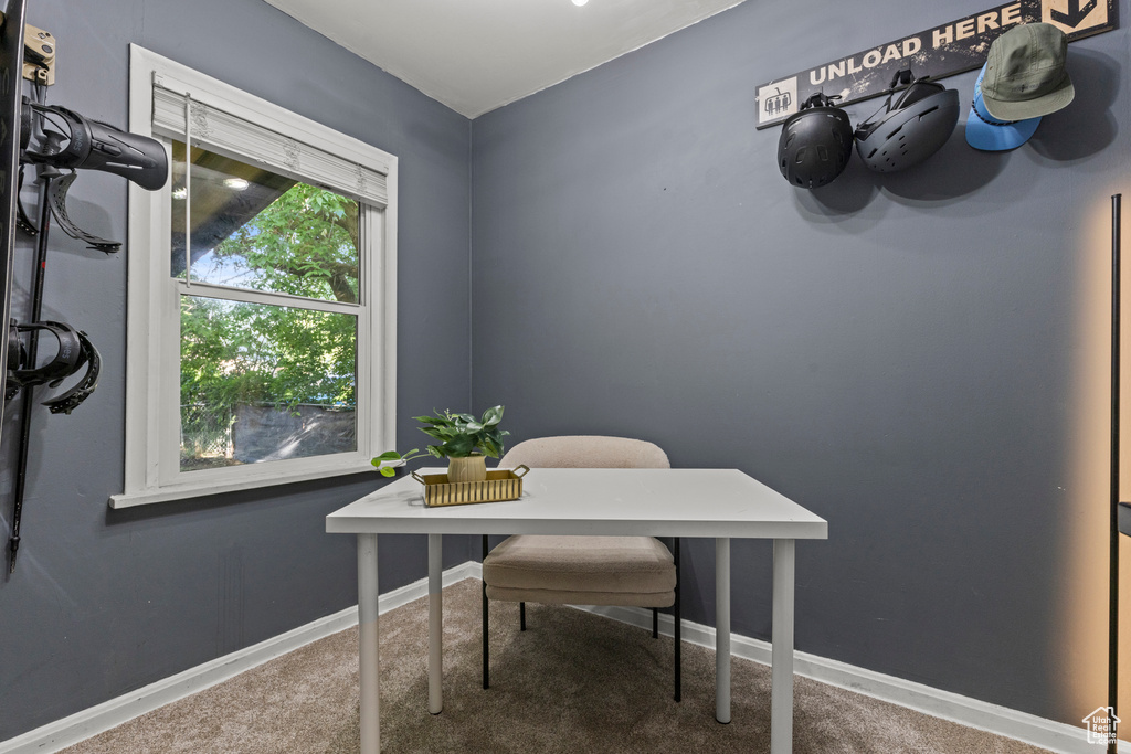 Carpeted office space featuring baseboards