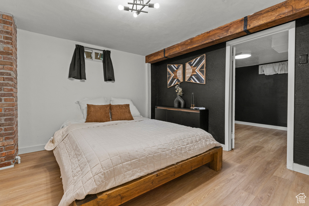Bedroom featuring wood finished floors and baseboards