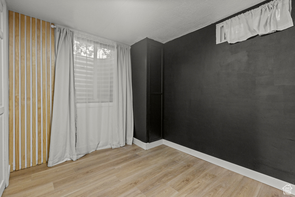 Empty room featuring light wood-style floors and baseboards