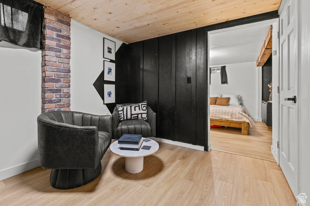 Living area featuring wooden ceiling, wood finished floors, and baseboards