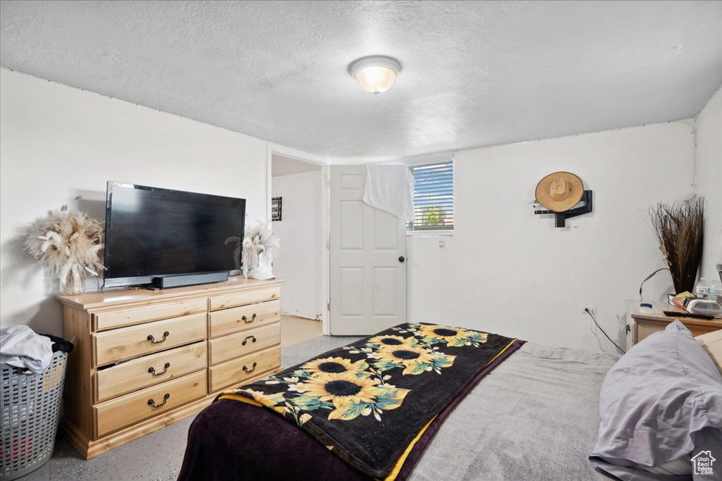 Bedroom with a textured ceiling