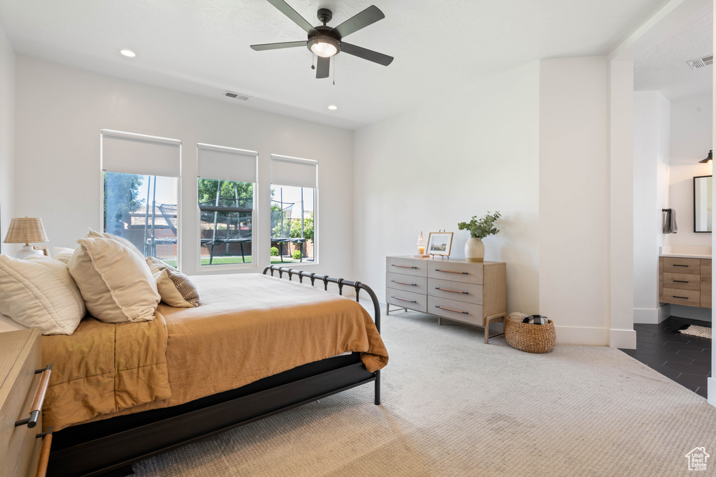 Carpeted bedroom featuring recessed lighting, baseboards, and a ceiling fan