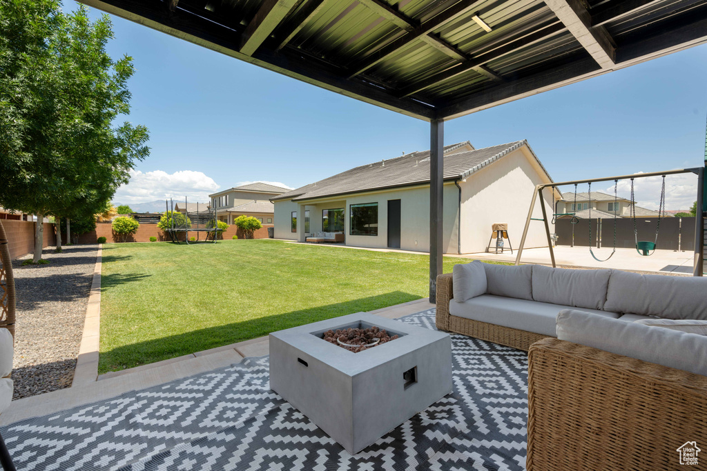 View of patio / terrace with an outdoor living space with a fire pit and a playground