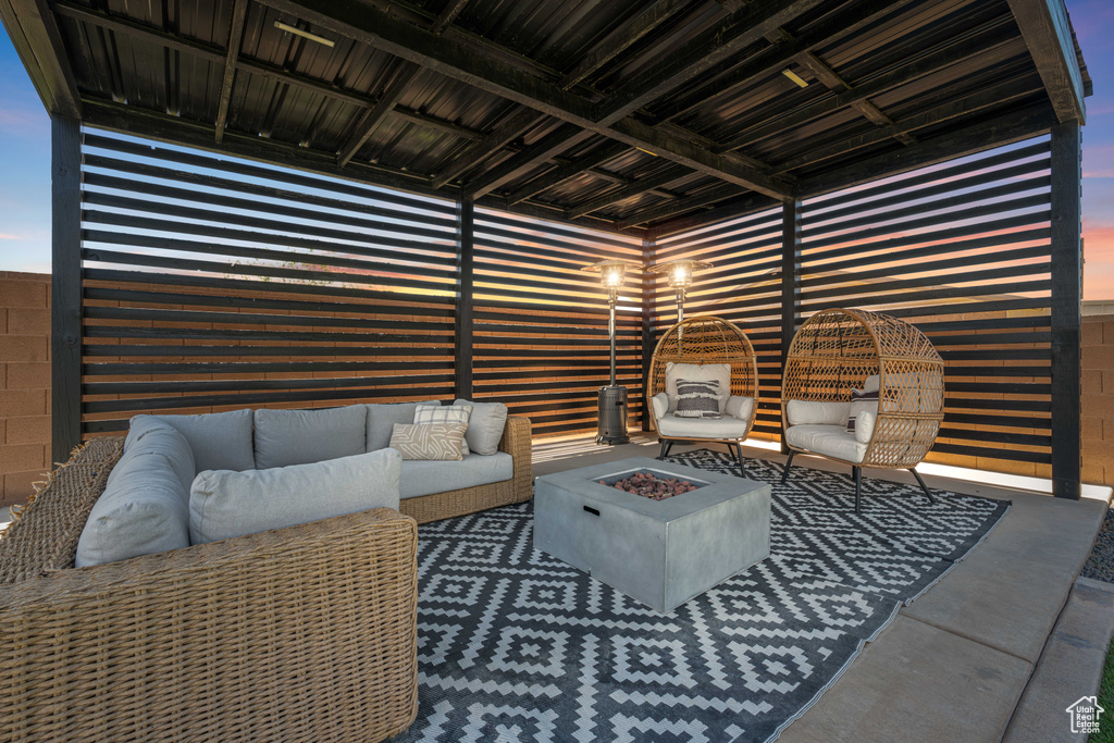View of patio featuring an outdoor living space with a fire pit