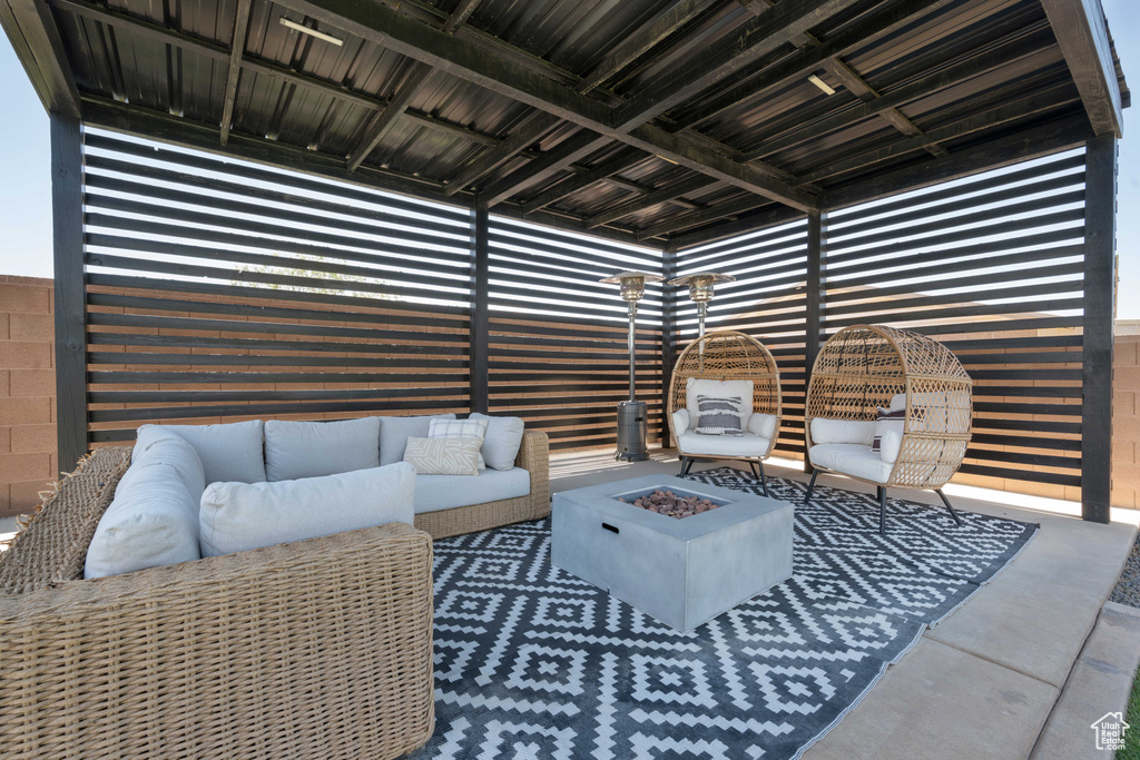 View of patio / terrace featuring an outdoor living space with a fire pit