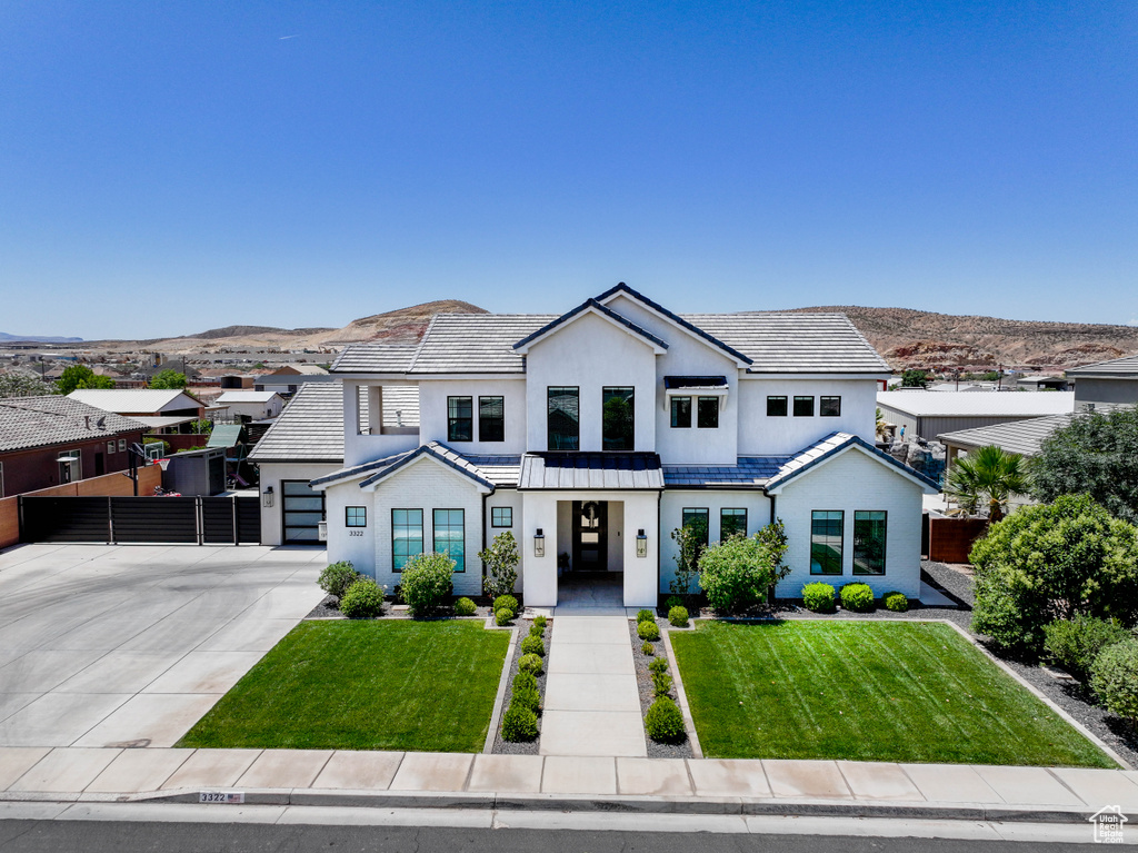 Modern farmhouse with concrete driveway, stucco siding, a tile roof, and a garage