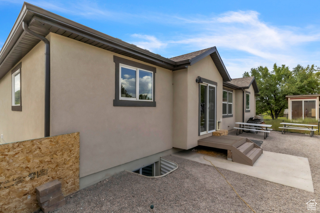View of property exterior featuring a patio and stucco siding