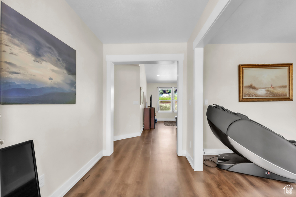 Hallway with wood finished floors and baseboards