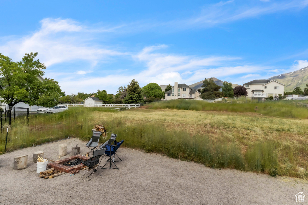 View of yard with a mountain view and an outdoor fire pit