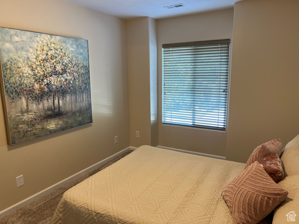 Carpeted bedroom with baseboards