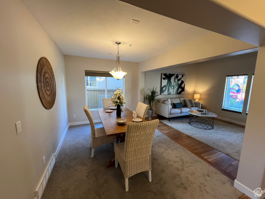 Carpeted dining room featuring baseboards