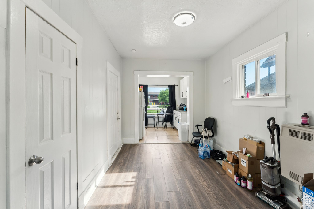 Hall with dark wood finished floors and baseboards