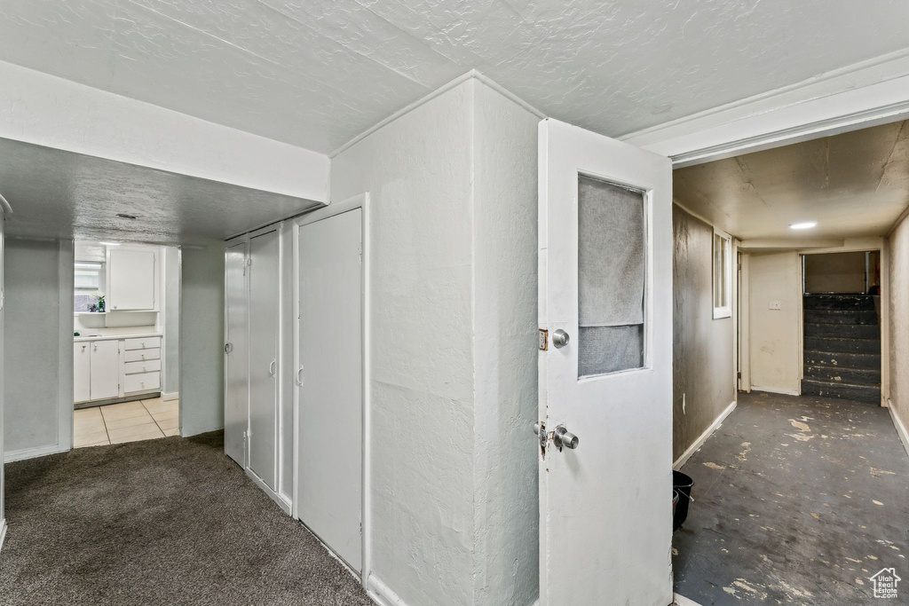 Hallway featuring stairs and baseboards