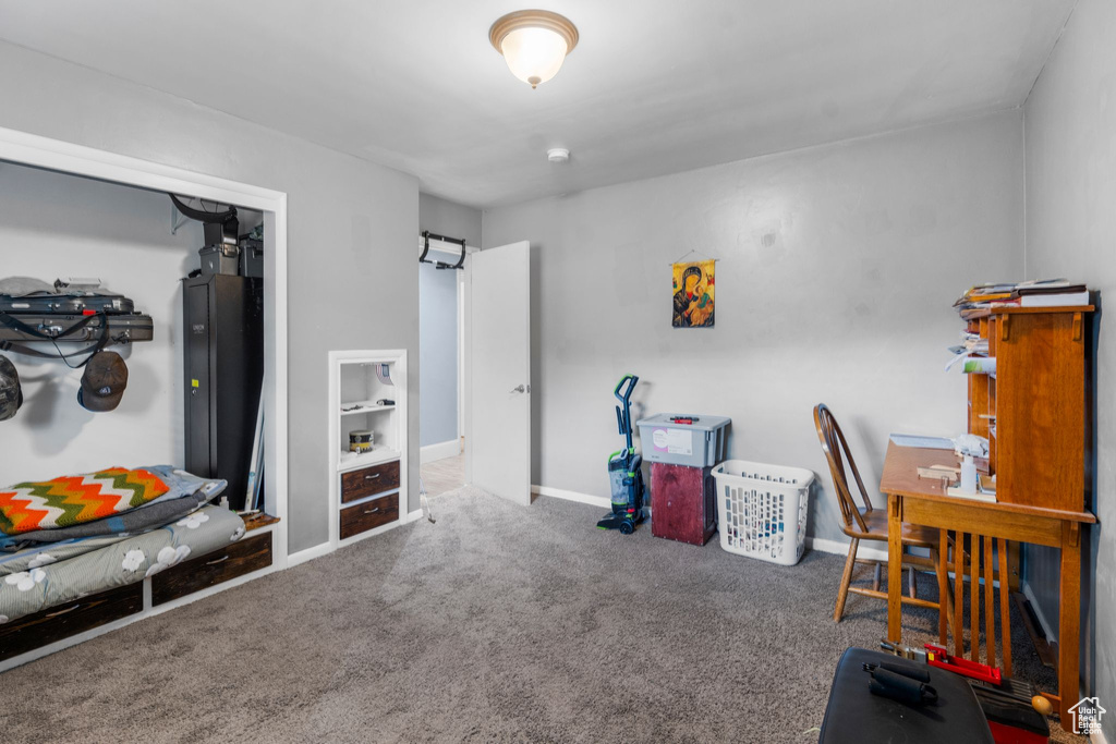 Carpeted home office featuring baseboards