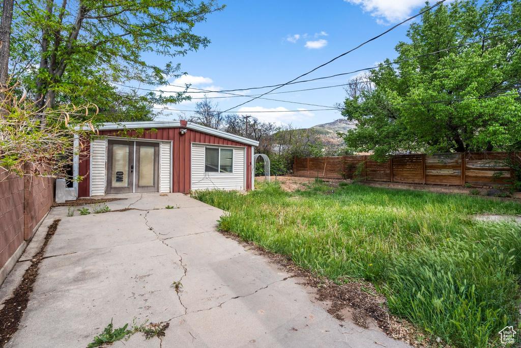 View of outbuilding with fence