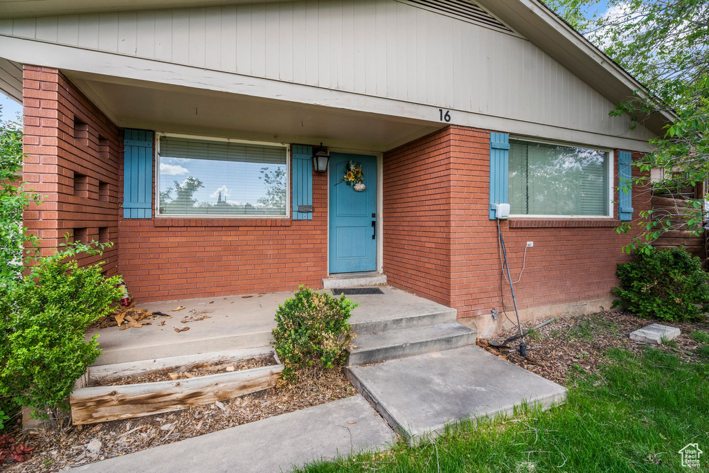 Doorway to property with brick siding