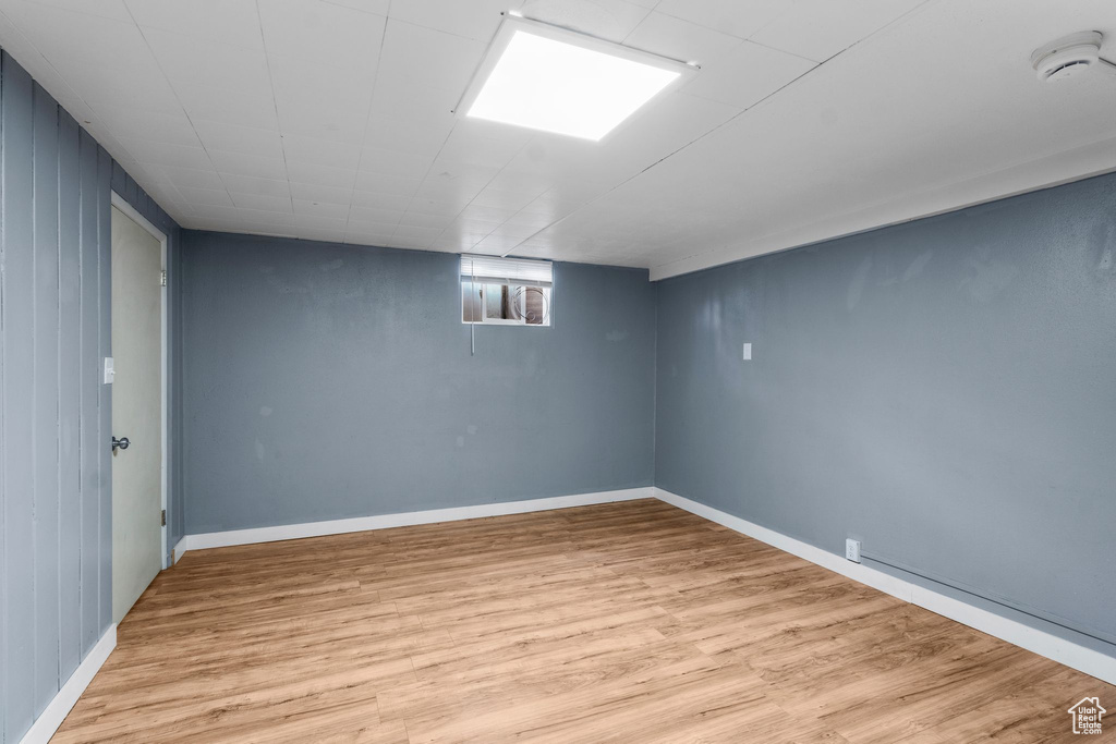 Below grade area with light wood-type flooring and baseboards