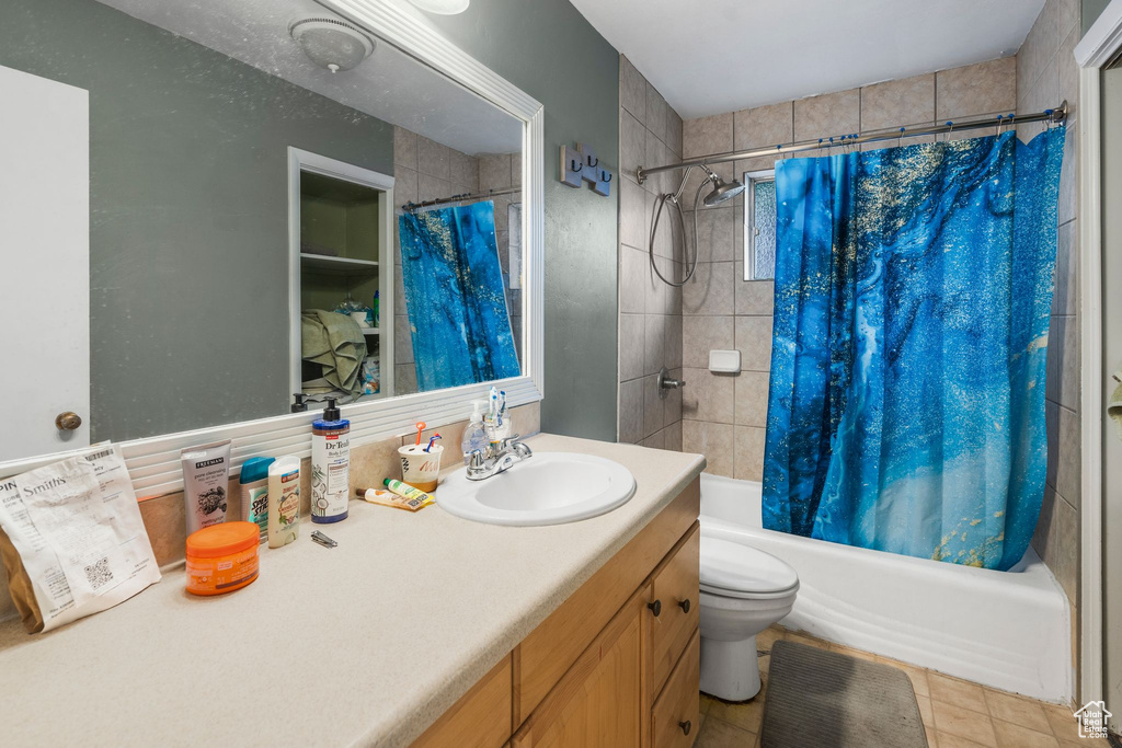 Full bathroom with shower / tub combo, vanity, and toilet