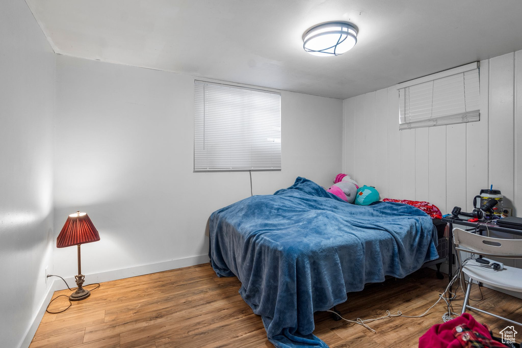 Bedroom with baseboards and wood finished floors