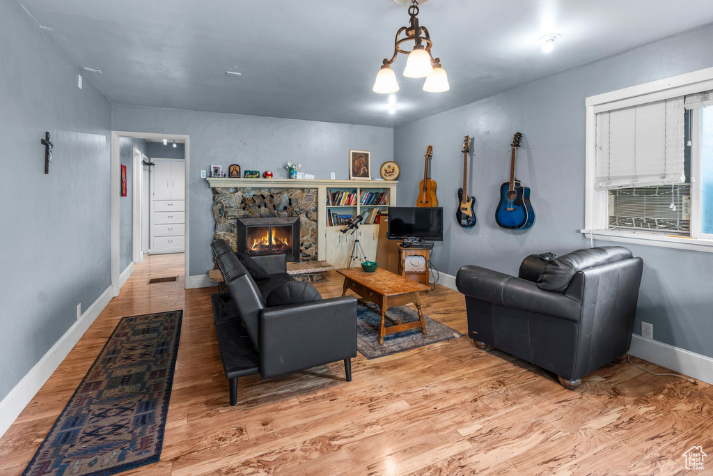 Living area with wood finished floors, baseboards, and a fireplace