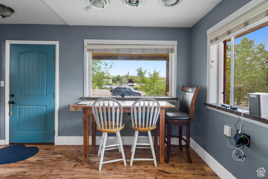 Dining space featuring wood finished floors and baseboards