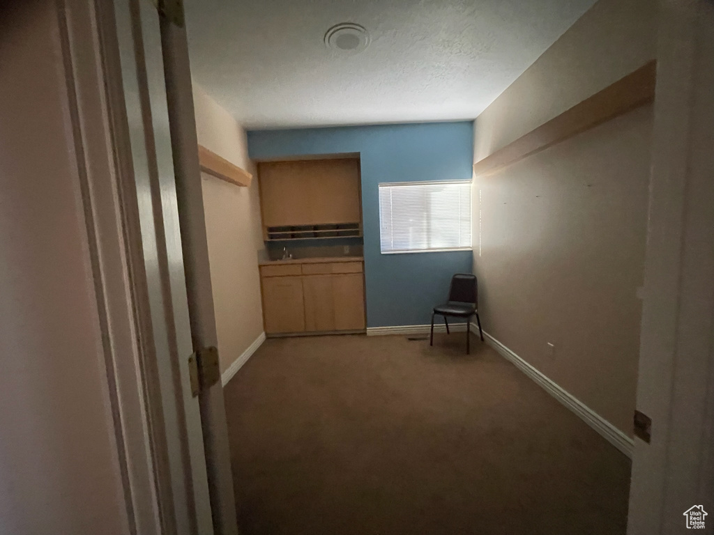 Unfurnished bedroom featuring light colored carpet and baseboards