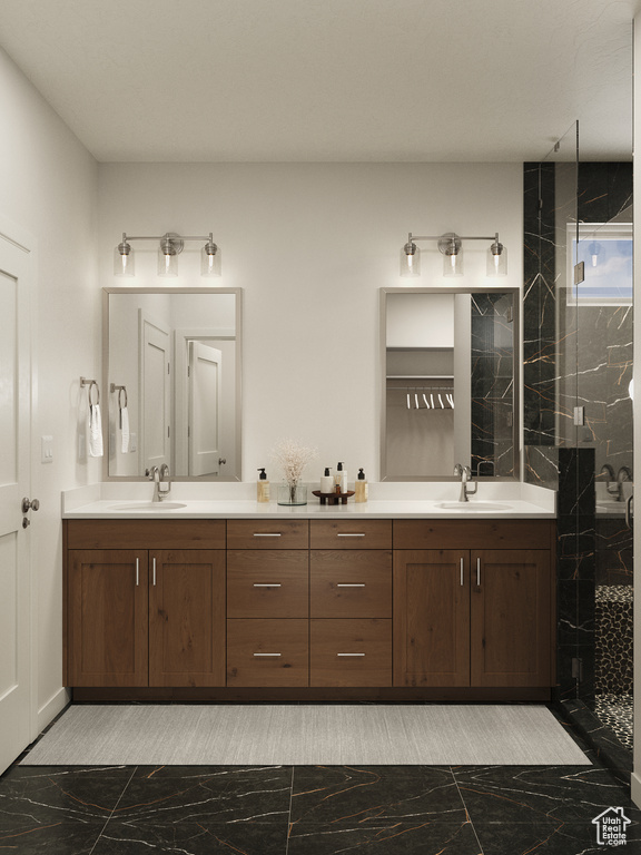 Full bathroom with marble look tiles, double vanity, and a tile shower