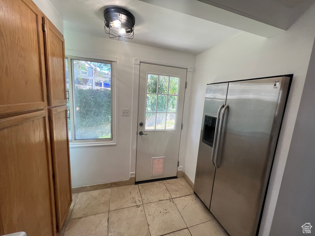 Doorway to outside featuring plenty of natural light and baseboards
