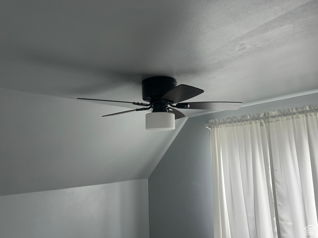 Detailed view of ceiling fan and a textured ceiling