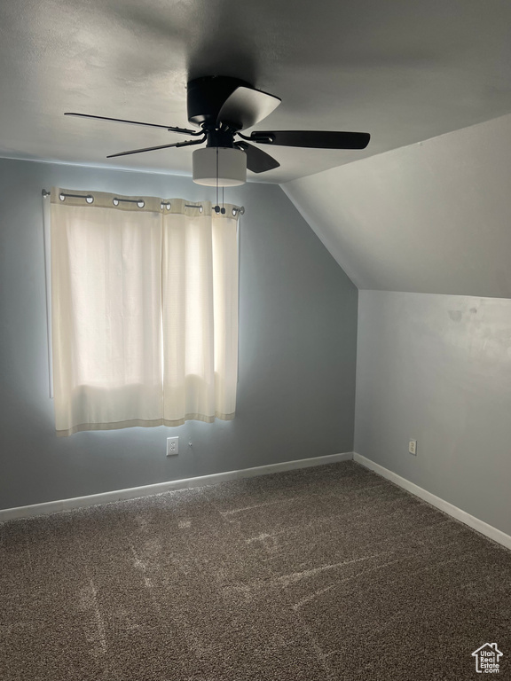 Additional living space featuring a ceiling fan, lofted ceiling, carpet flooring, and baseboards