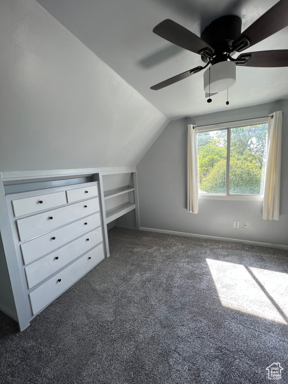 Additional living space with carpet floors, lofted ceiling, and a ceiling fan