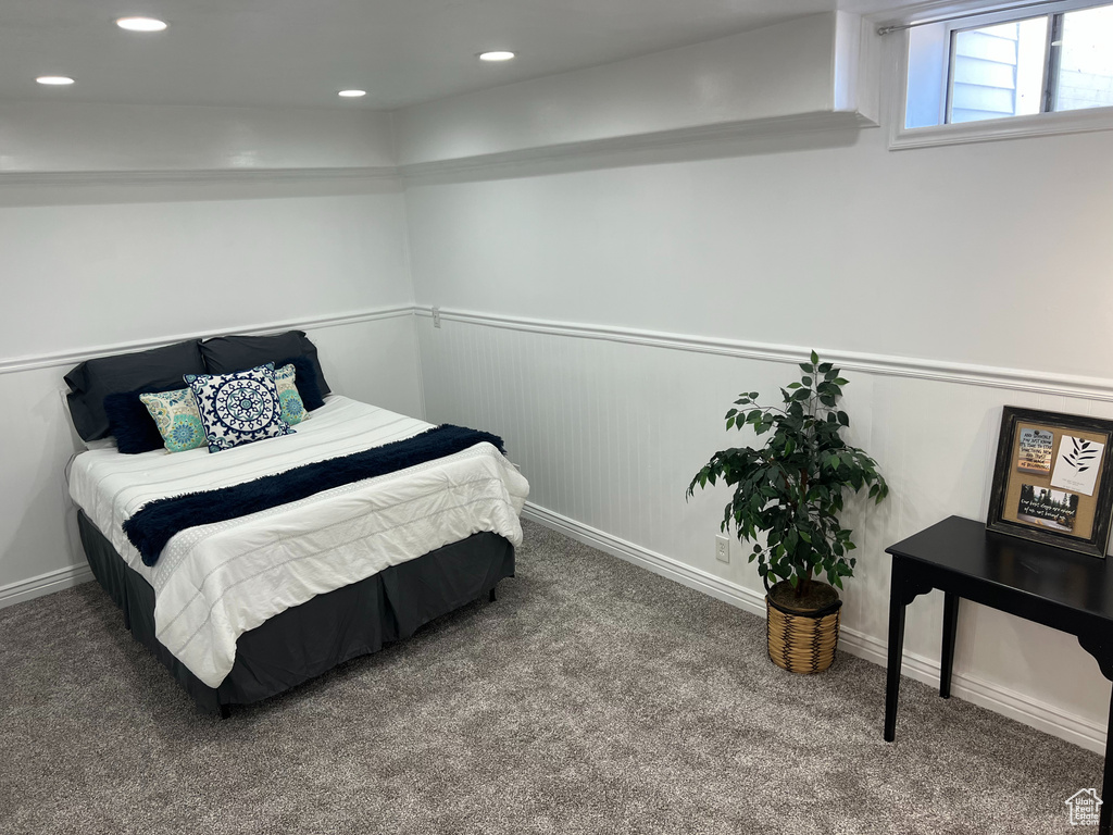 Carpeted bedroom featuring wainscoting and recessed lighting