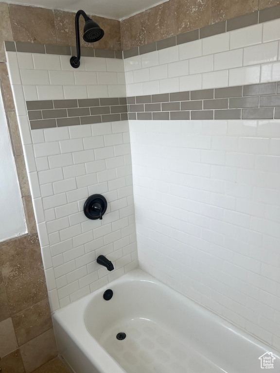Bathroom featuring washtub / shower combination