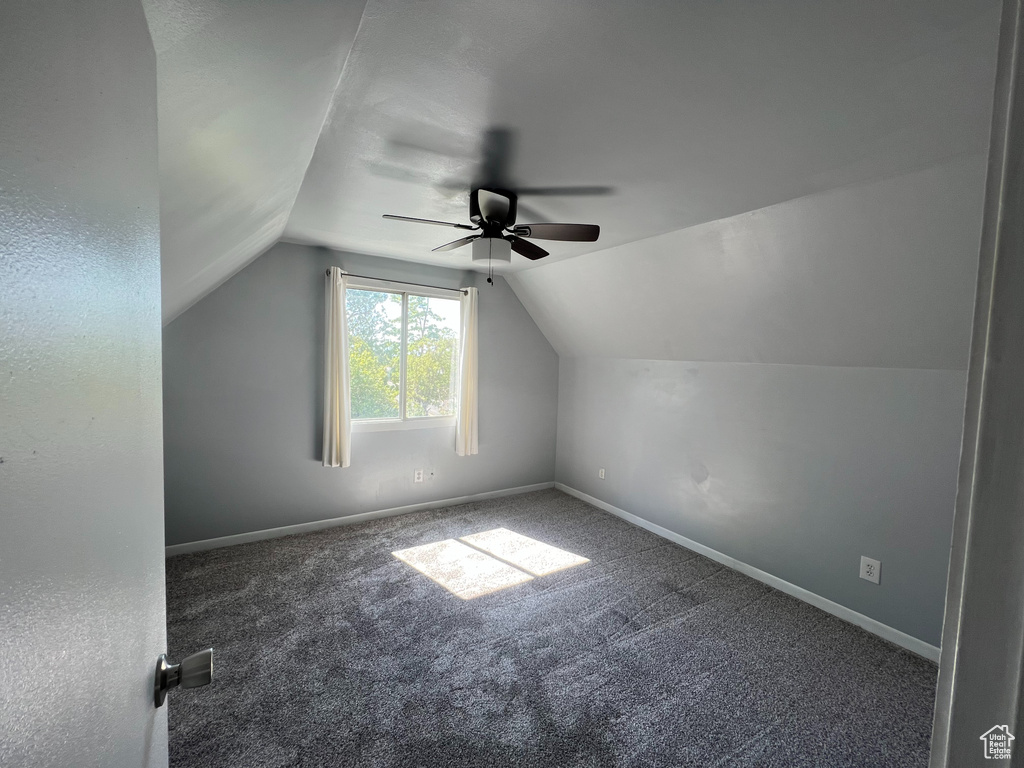 Bonus room featuring a ceiling fan, vaulted ceiling, carpet flooring, and baseboards