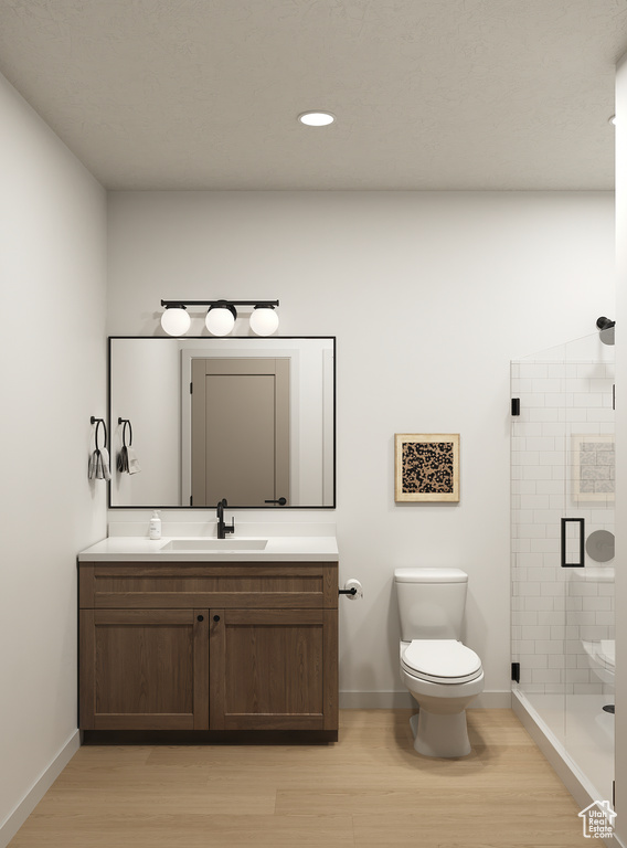 Full bathroom featuring toilet, vanity, wood finished floors, a stall shower, and recessed lighting