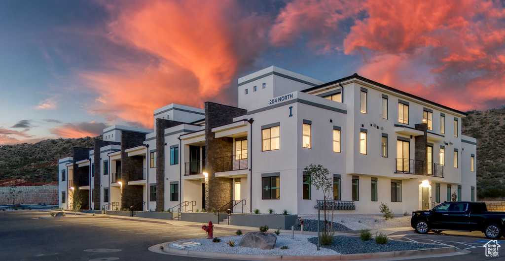 View of property at dusk