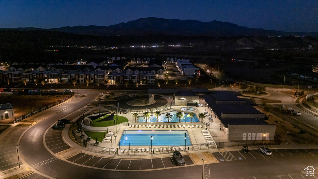Aerial view at night of view of pool area and a mountain view