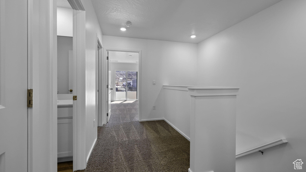 Corridor featuring carpet flooring, an upstairs landing, recessed lighting, and baseboards