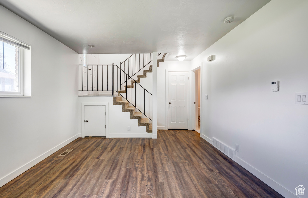 Interior space with wood finished floors, baseboards, and stairway