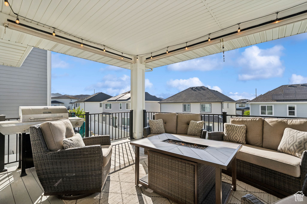 View of patio with an outdoor living space with a fire pit, a residential view, and a grill