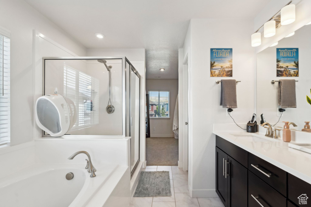 Full bathroom with vanity, a stall shower, a garden tub, tile patterned floors, and recessed lighting