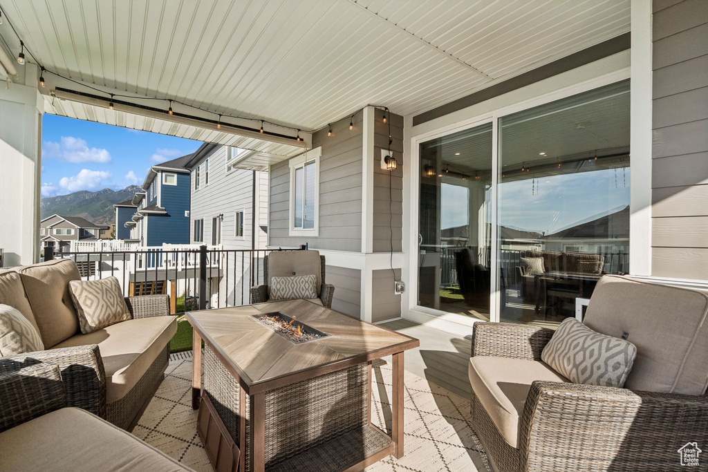 View of patio / terrace with an outdoor living space with a fire pit and a mountain view