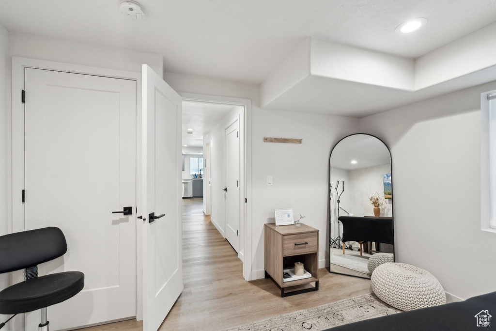 Corridor with light wood finished floors, recessed lighting, and baseboards