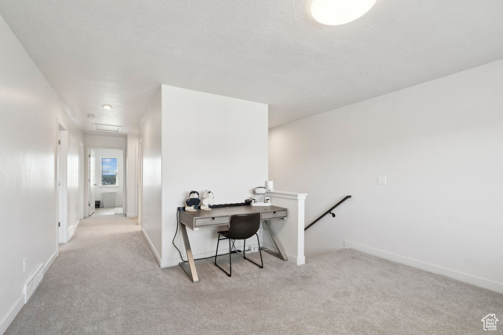 Carpeted office space with baseboards