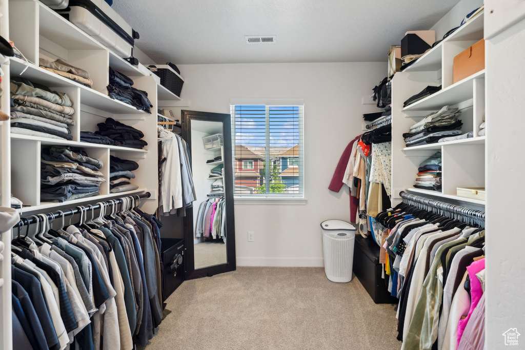 Walk in closet featuring carpet flooring