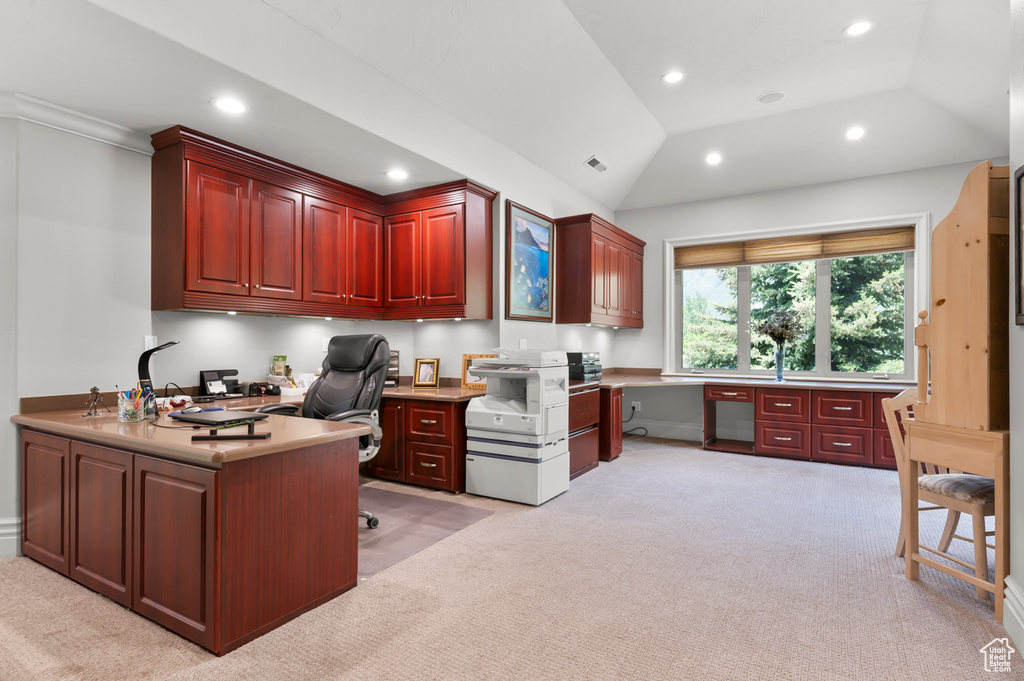 Office area featuring light carpet, built in desk, recessed lighting, and lofted ceiling